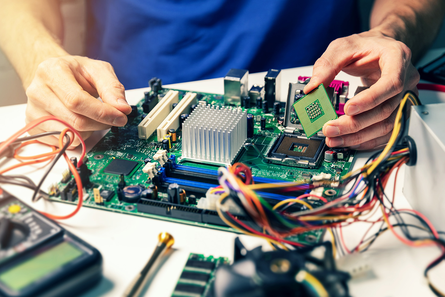 A man working on a computer circuit board.