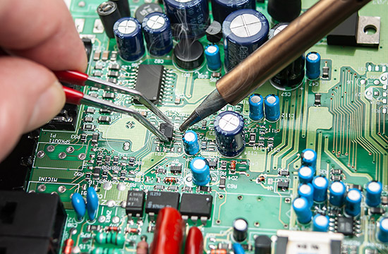 Technician soldering a circuit board